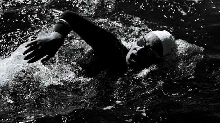 Engaging shot of a swimmer in Viana do Castelo, Portugal during a triathlon.